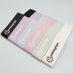 Set of cookiegrips pickleball edge guard tape in various colors on a light gray background