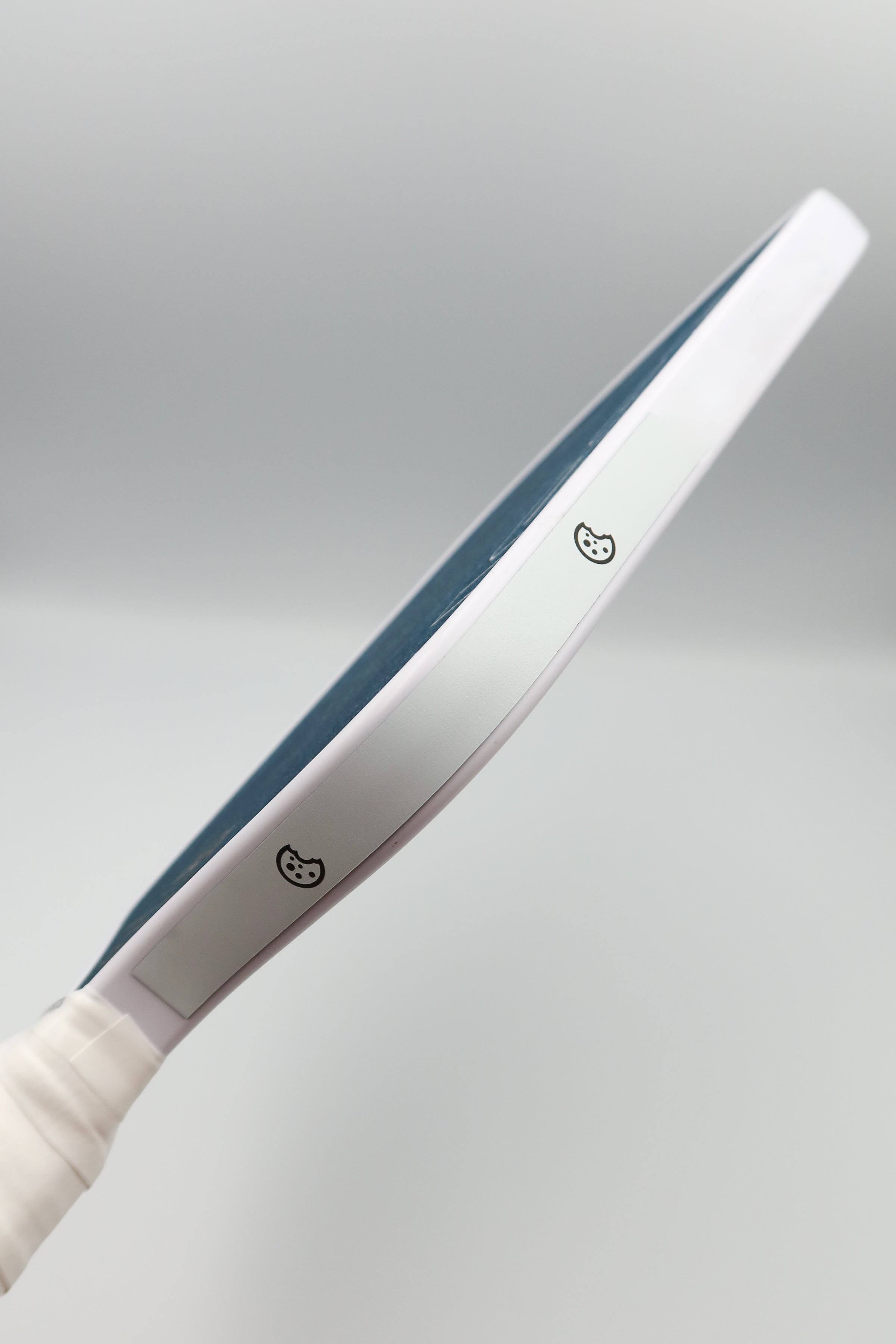 Sugar Glaze white cookiegrips Extra Batter tuning tape applied along the edge of a pickleball paddle