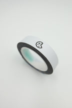 Roll of white tuning weighted pickleball tape with a black cookiegrips logo on a light gray background