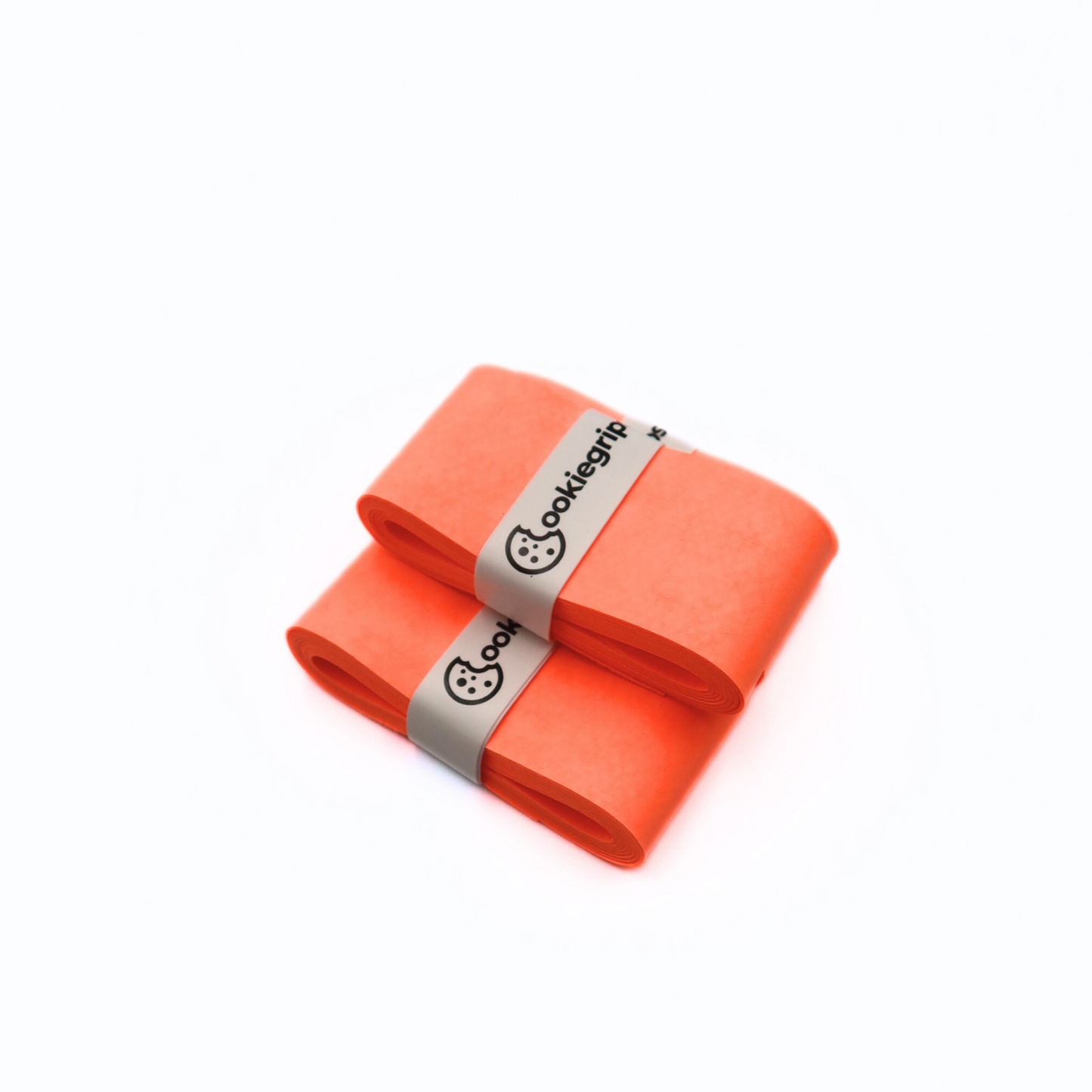 Three Cookiegrips Tough Cookie pickleball and tennis overgrips in orange, rolled and banded with white Cookiegrips logo wraps on a white background.