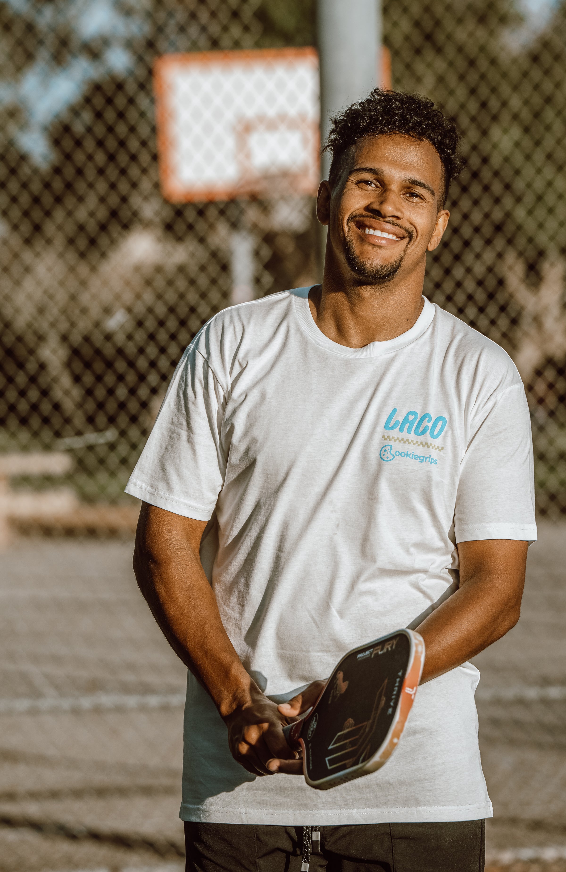 Man holding a pickleball paddle in the cream LACO x cookiegrips Now Serving T-shirt