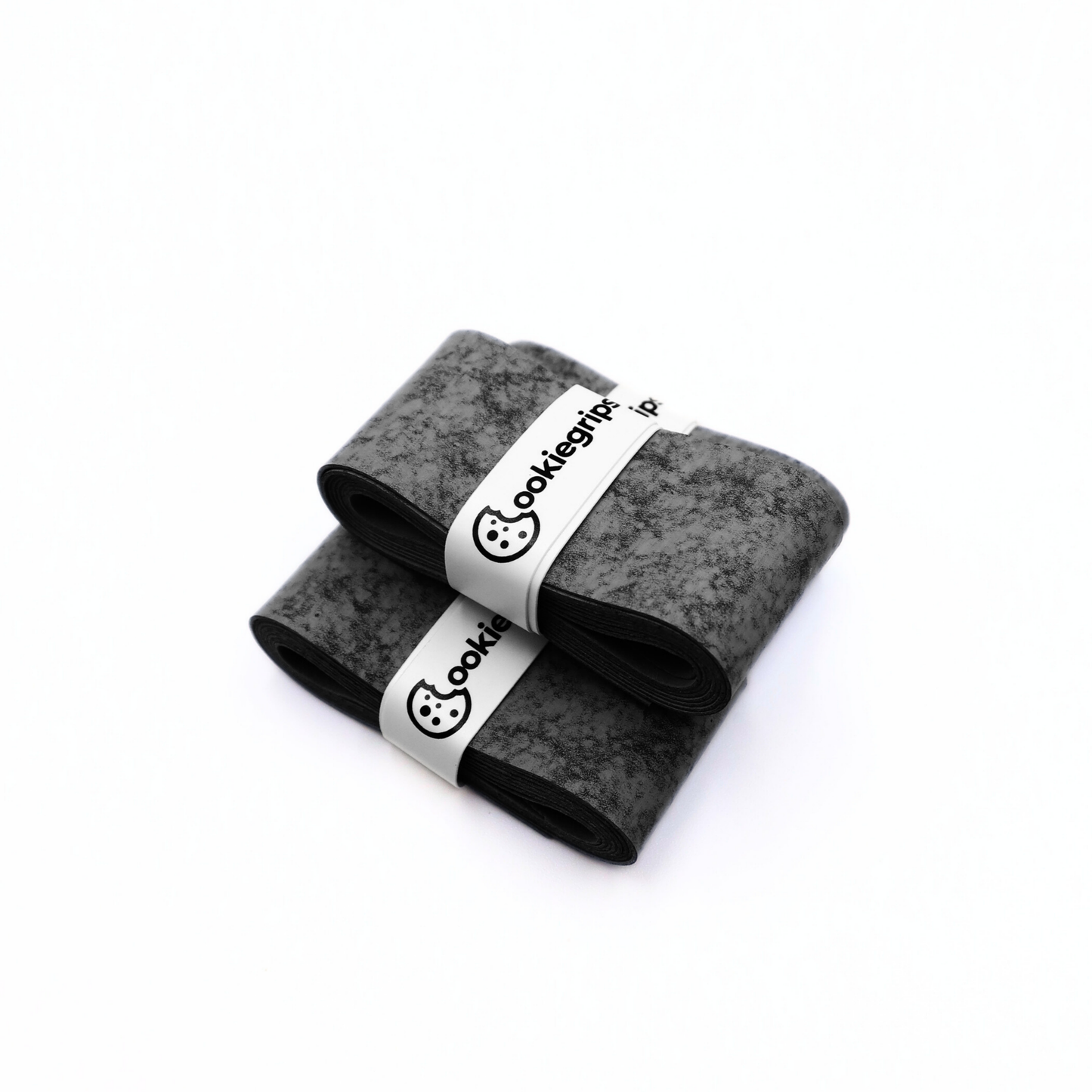 Three Cookiegrips Tough Cookie pickleball and tennis overgrips in speckled grey, rolled and banded with white Cookiegrips logo wraps on a white background.