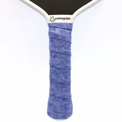 Cookiegrips Tough Cookie pickleball paddle handle wrapped with speckled blue overgrip, showing textured dry grip and clean white paddle throat.
