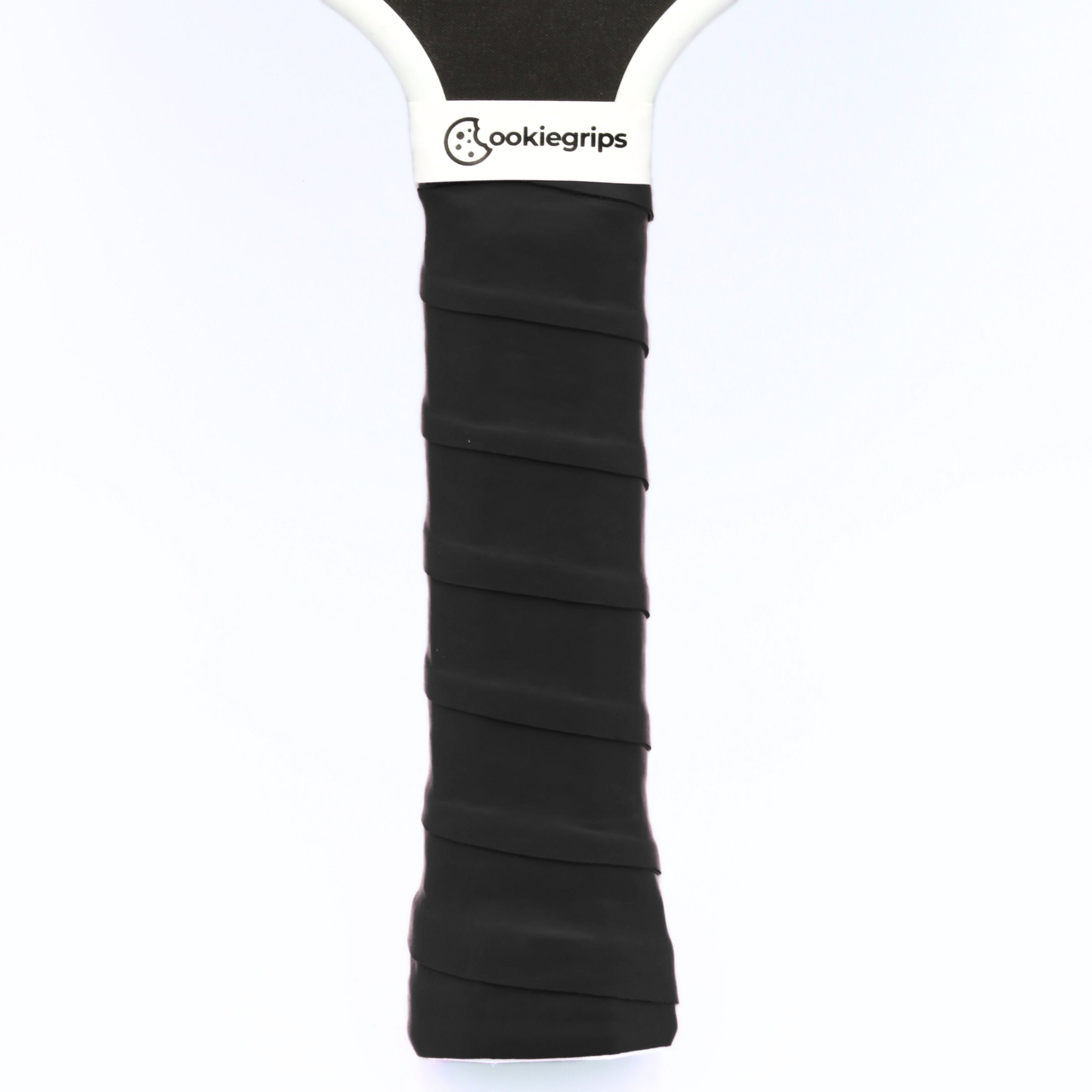 cookiegrips black pickleball overgrip wrapped on paddle handle — tacky grip tape for comfort and control.