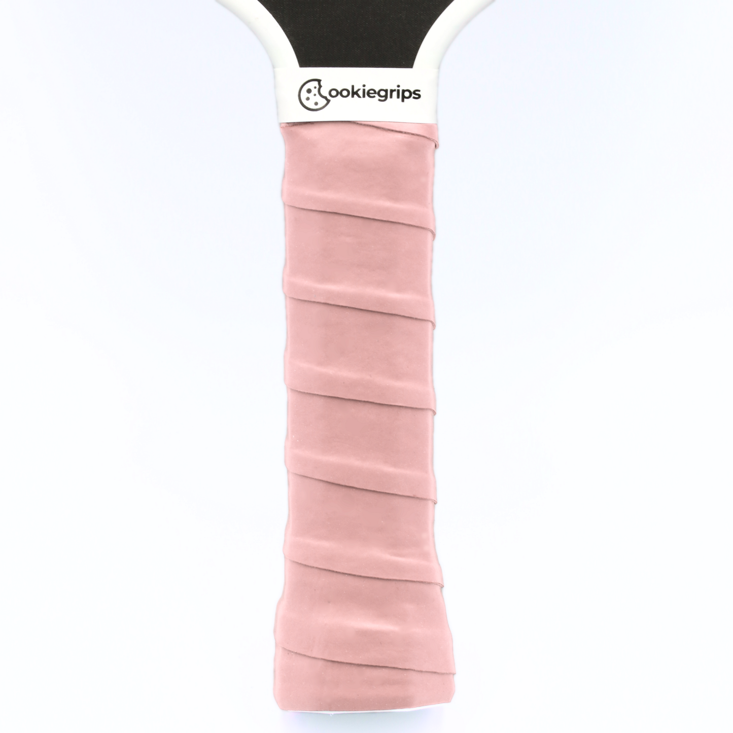 Light pink cookiegrips pickleball paddle overgrip – soft tacky overgrip applied to paddle handle for comfort and control.