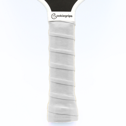 cookiegrips white pickleball overgrip wrapped on paddle handle — tacky grip tape for comfort and control.