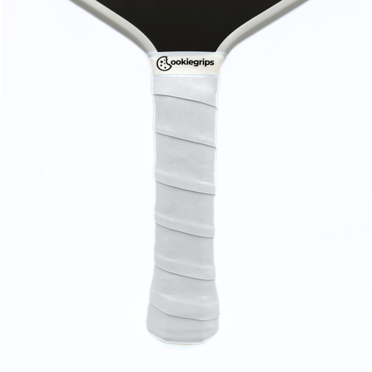 Cookiegrips Tough Cookie pickleball paddle handle wrapped with white overgrip, showing textured dry grip and clean white paddle throat.